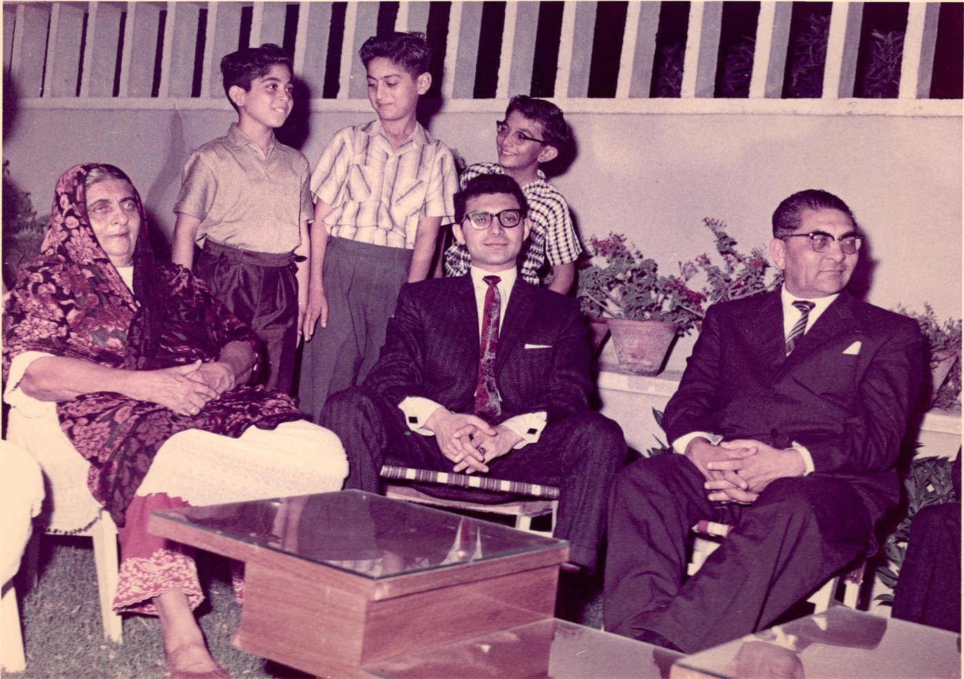 Hanifa Bai seated with her son, Ahmed Dawood, alongside family members at their family home