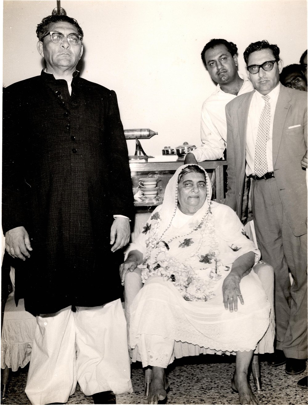 Ahmed (left) and Siddique (right) Dawood standing beside their mother, Hanifa Bai